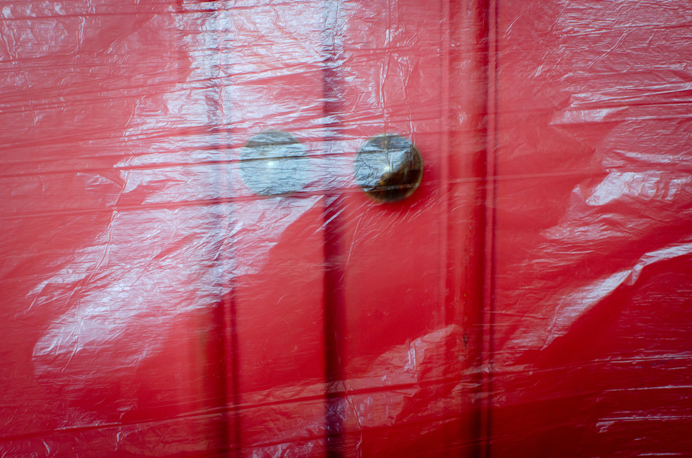 door wrapped in plastic to avoid living on site