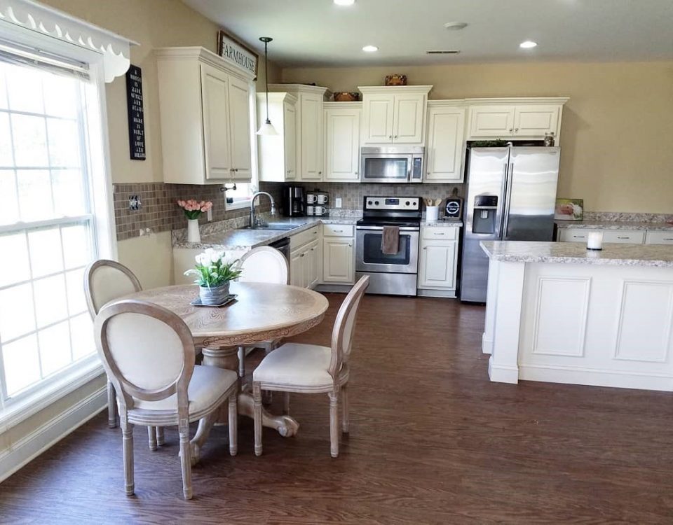 open plan kitchen with dining table and chairs